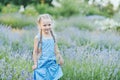 Little girl in lavender field. kids fantasy. Smiling girl sniffing flowers in summer purple lavender field Royalty Free Stock Photo