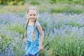 Little girl in lavender field. kids fantasy. Smiling girl sniffing flowers in summer purple lavender field Royalty Free Stock Photo