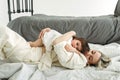 The little girl lay down on her mother and wants to sleep. Mom tenderly hugs her daughter