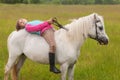 The little girl lay on her back white horse Royalty Free Stock Photo