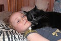 Little girl laying in bed together with her cat. Together with your pet Royalty Free Stock Photo