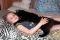 Little girl laying in bed together with her cat. Together with your pet Royalty Free Stock Photo