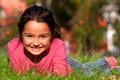 Little girl laying on grass