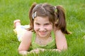 Little Girl Laying in the Grass Laughing Royalty Free Stock Photo