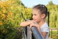 Little girl is lean elbow on bridge fence Royalty Free Stock Photo