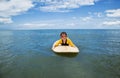 Little girl learn to surf at ocean