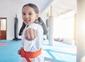 A little girl learning big lessons. Shot of a cute little girl practicing karate in a studio.