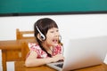 Little girl learning computer in classroom