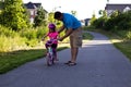 Little girl learning how to ride a bike with her dad Royalty Free Stock Photo