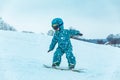 Little girl learning snowboarding Royalty Free Stock Photo
