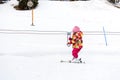 Little girl is learning to ski in ski resort. Royalty Free Stock Photo