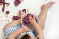 Little girl is learning to use colorful play dough in a well lit room. Royalty Free Stock Photo