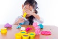 Little girl is learning to use colorful play dough Royalty Free Stock Photo