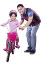 Little girl learns riding a bike with dad Royalty Free Stock Photo