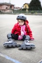 Little girl learns to skate with rollerblading at the basketball