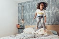 Little girl legs jumping high in her parents bed Royalty Free Stock Photo