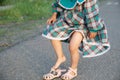 Little girl legs wearing open-toe sandals at summer. Kid in green dress Royalty Free Stock Photo