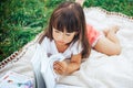 Little girl lie on grass and reading book Royalty Free Stock Photo