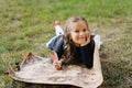 Little Girl Lie On Ground Look At Ancient Map