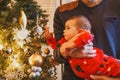 A little girl lies in her father s arms and looks at the Christmas tree toys Royalty Free Stock Photo