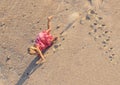 Little Girl with light hair falls from the mountain of sand