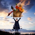 Little girl like a vampire on evening sky background holding box with different things, collage, artwork Royalty Free Stock Photo