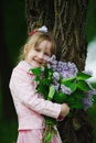 Little girl with lilac bouquet