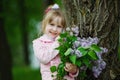 Little girl with lilac bouquet