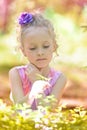 Little girl in a lilac dress with a flower in her hair