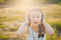 Little girl listening music with headphones