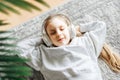 Little girl listening music lying on the floor Royalty Free Stock Photo