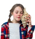 Little girl listening a shell Royalty Free Stock Photo