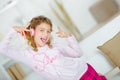 Little girl listening to music through headphones inside Royalty Free Stock Photo