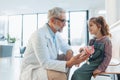 Little girl listening to the plush toy's heartbeat with stethoscope. Role reversal. Friendly relationship between