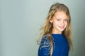 Little girl with long hair. Fashion model, beauty, look. Stylish girl with pretty face on grey background. Hairdresser