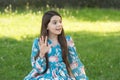 Little girl long hair fashionable dress relaxing in park sunny day nature background, say hello concept