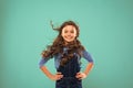 Little girl with long hair. Kid happy cute face with adorable curly hair stand over blue background. Pure beauty. Beauty Royalty Free Stock Photo