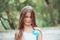 Little girl with long hair portrait, emotionally crying and upset, natural lighting outside Royalty Free Stock Photo