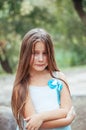 Little girl with long hair portrait, emotionally crying and upset, natural lighting outside