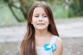 Little girl with long hair portrait, emotionally crying and upset, natural lighting outside