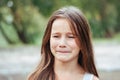 Little girl with long hair portrait, emotionally crying and upset, natural lighting outside Royalty Free Stock Photo