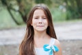 Little girl with long hair portrait, emotionally crying and upset, natural lighting outside