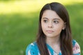 Little girl with long hair relaxing in park sunny day green grass background, international childrens day concept Royalty Free Stock Photo