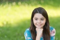 Little girl with long hair relaxing in park sunny day green grass background, optimism and positivity concept Royalty Free Stock Photo