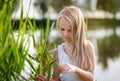 Little girl with long hair is sad, thoughtful, outdoors