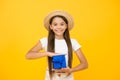 Little girl long hair summer hat hold gift box, vacation souvenir concept Royalty Free Stock Photo