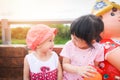 Little girl look in the eyes - Children having fun playing outside Asian kids girl sitting on a bench happy with toys in the Royalty Free Stock Photo