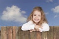Little girl looking from above a fence, Royalty Free Stock Photo