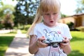 Little girl looking with a big suprise to a vintage film camera