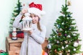 Little girl looking at burning candle inside white steel lantern in her hand, Christmas eve Royalty Free Stock Photo